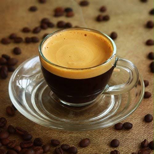 Freshly brewed espresso with coffee beans
