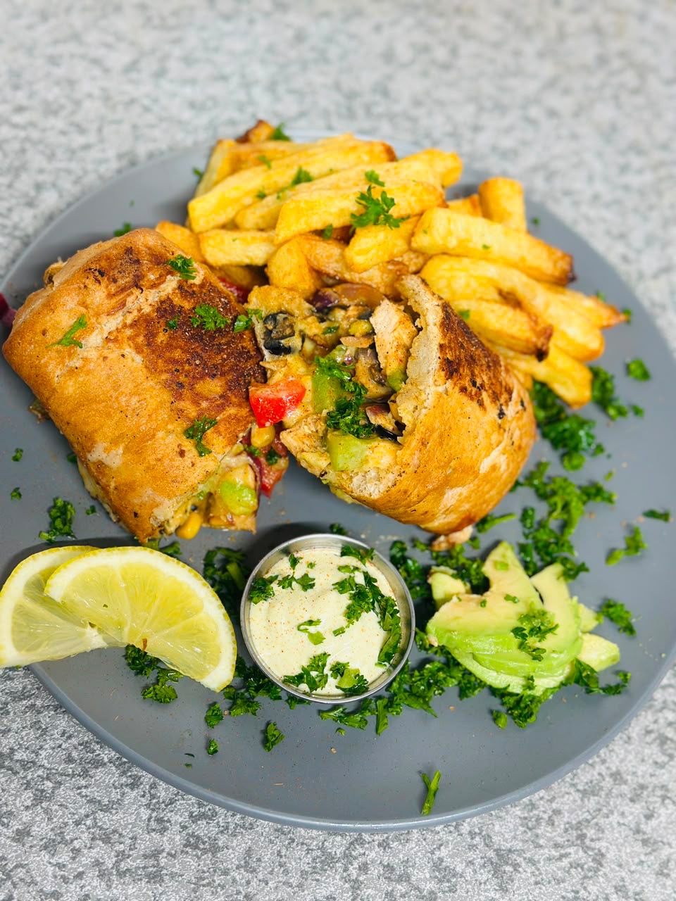 Grilled chicken wrap with fries, tahini and avocado