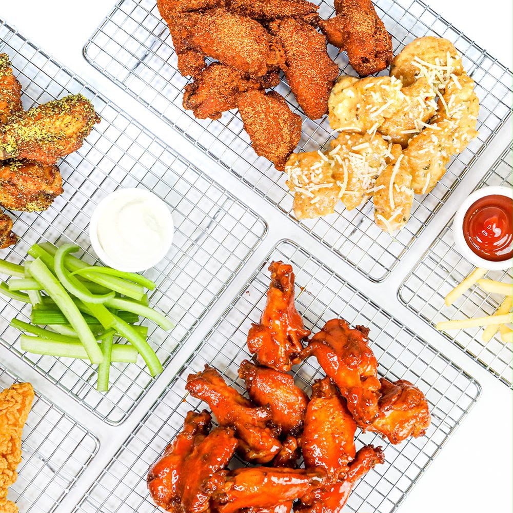 Assorted chicken wings platter with dips and celery